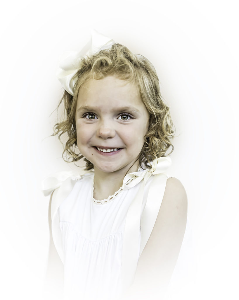 Color Heirloom Portrait Little Girl Wearing a white sleeveless dress Smiling at the Camera 