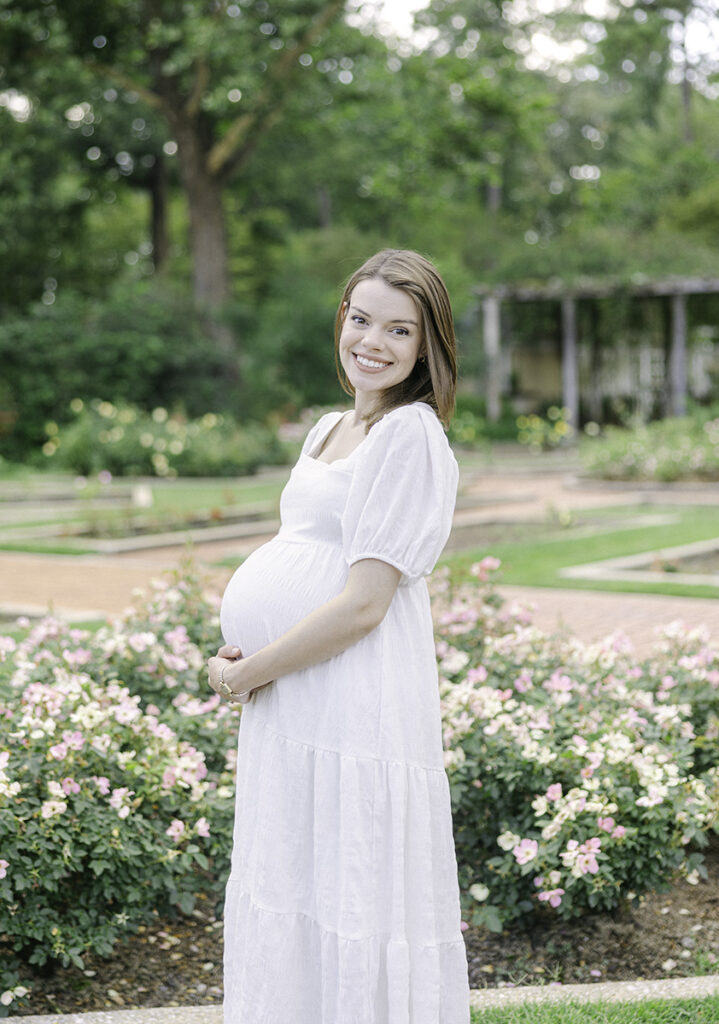 Pregnant mom holding belly and looking and smiling by Birmingham Maternity Photographer 