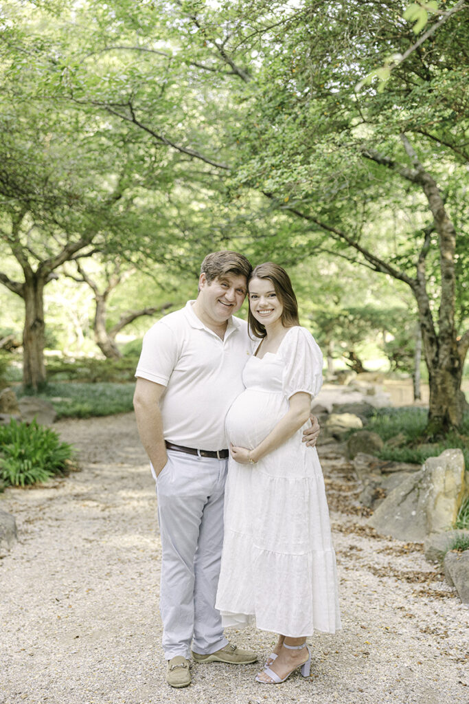 Pregnant Mom and Dad smiling at the camera by Birmingham Maternity Photographer 