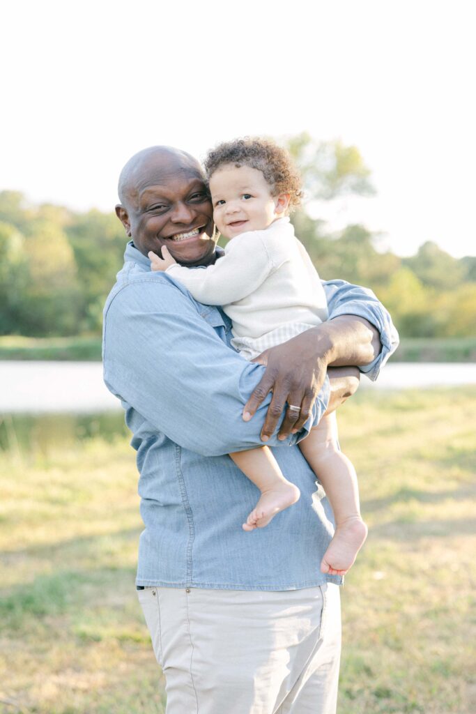 Dad holding toddler boy and giving him a big hug at a Birmingham lifestyle session - Whitney Carr Photography
